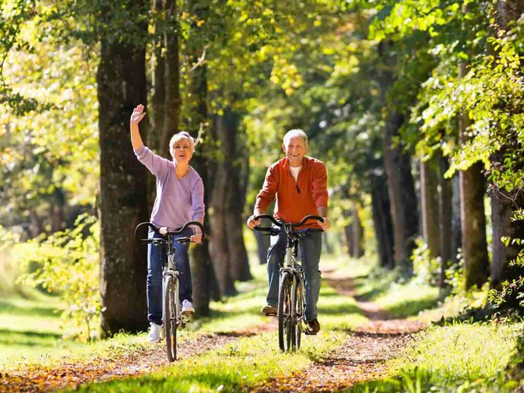 old couple riding bike in the jungle