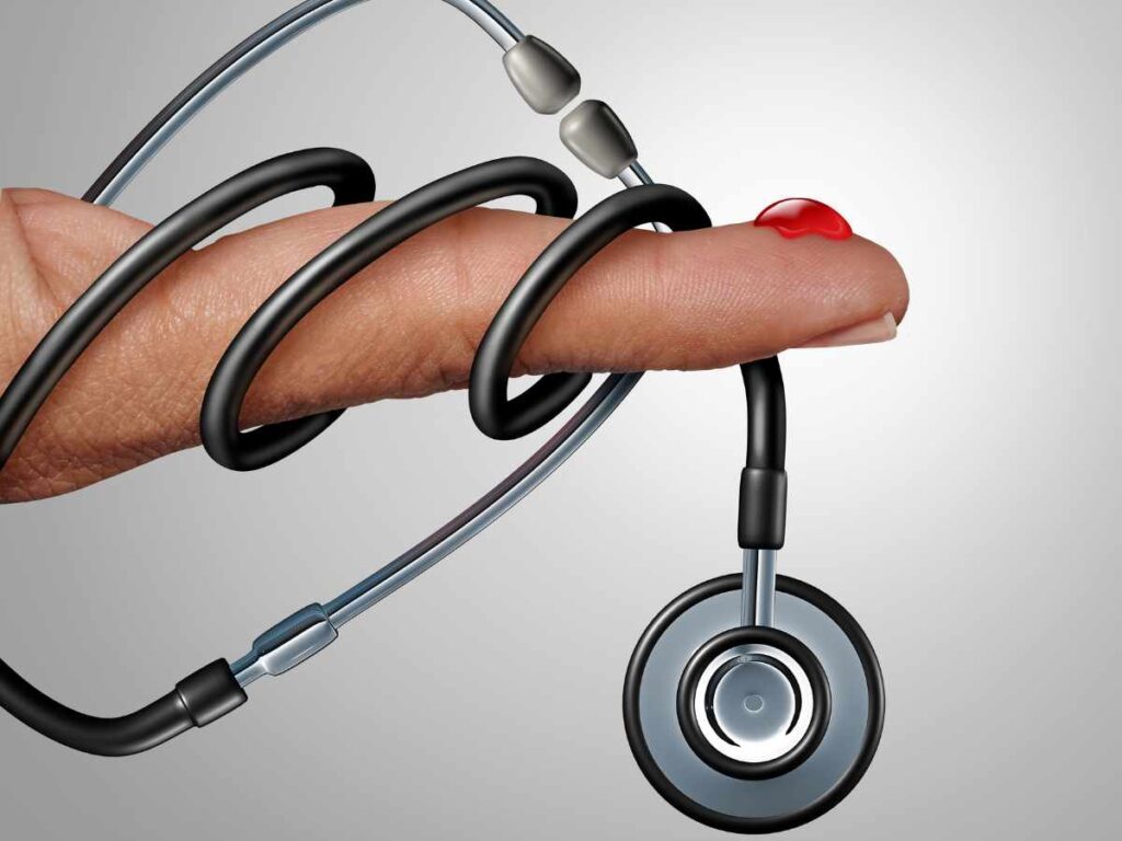 finger with stethoscope and blood drop on it