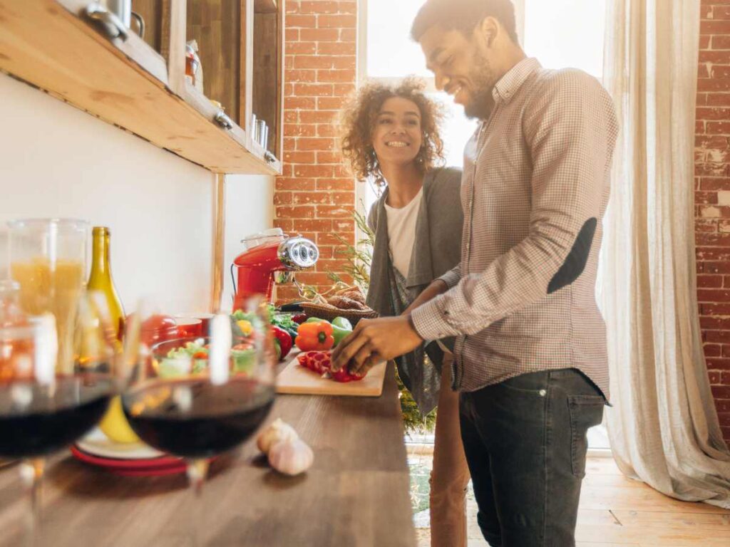 coiple cooking food in kitchen