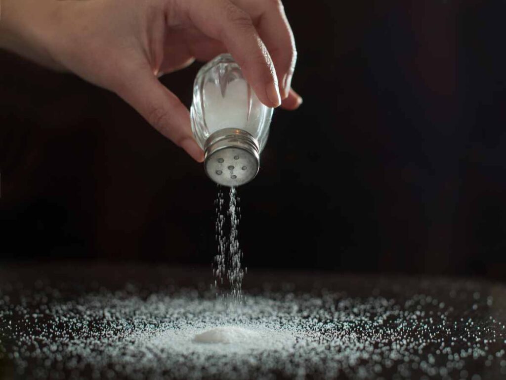 dropping salt on the table