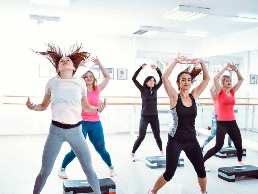 group of friends doing zumba at the gym