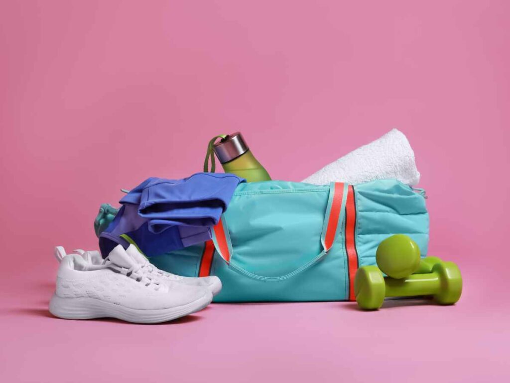 gym bag with shoes, towel, dumbbell and bottle