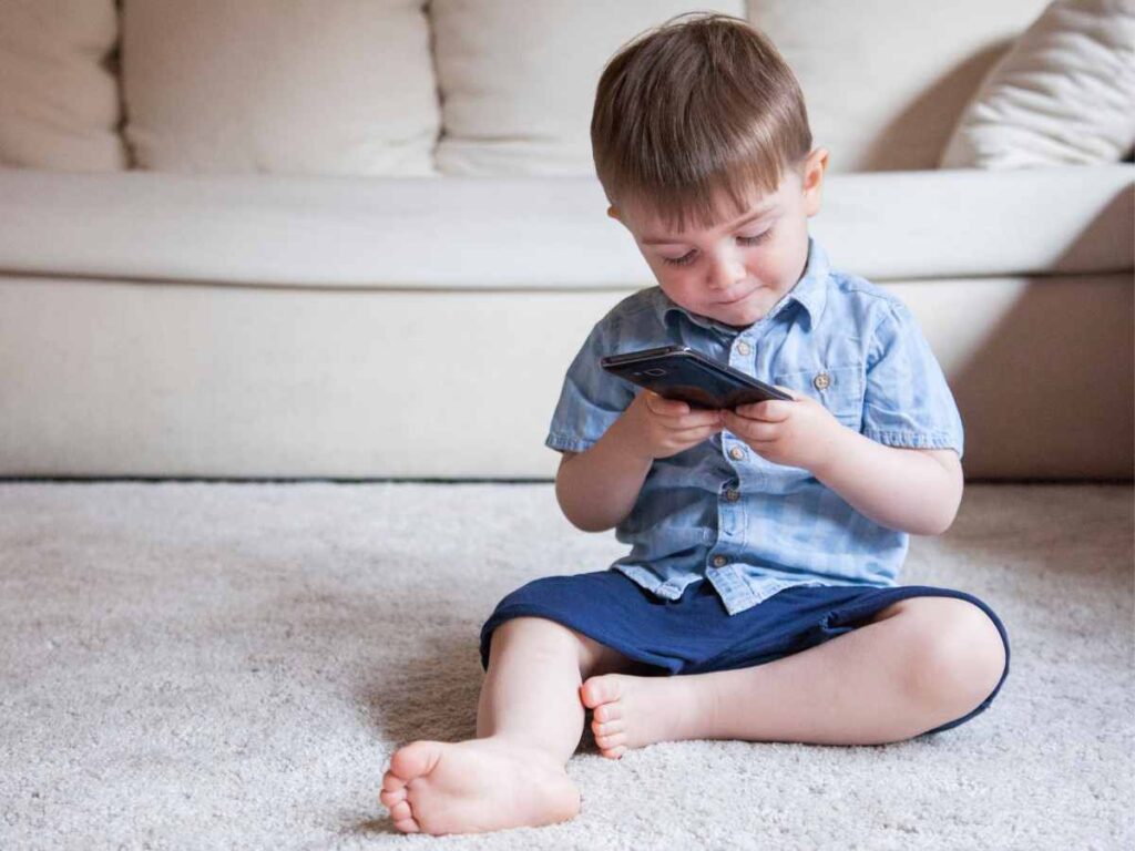 kid using mobile phone and getting affected with its radiations