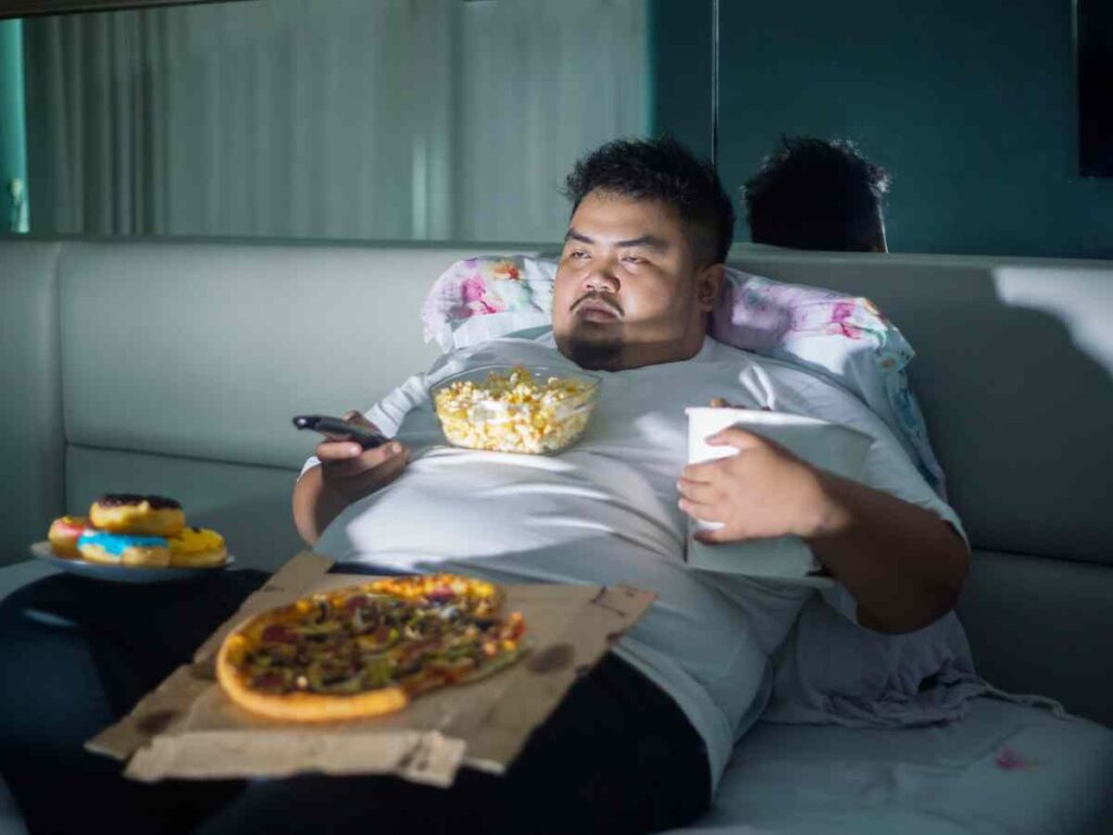 a man consuming too much junk food