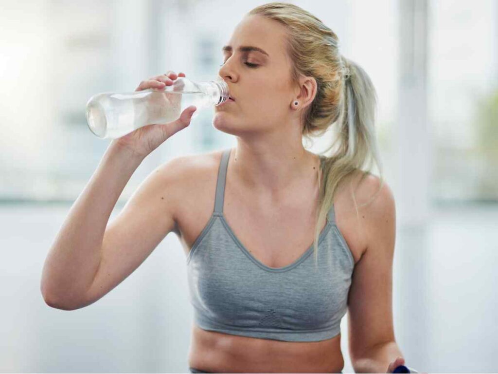 lady drinking water to maintain temperature