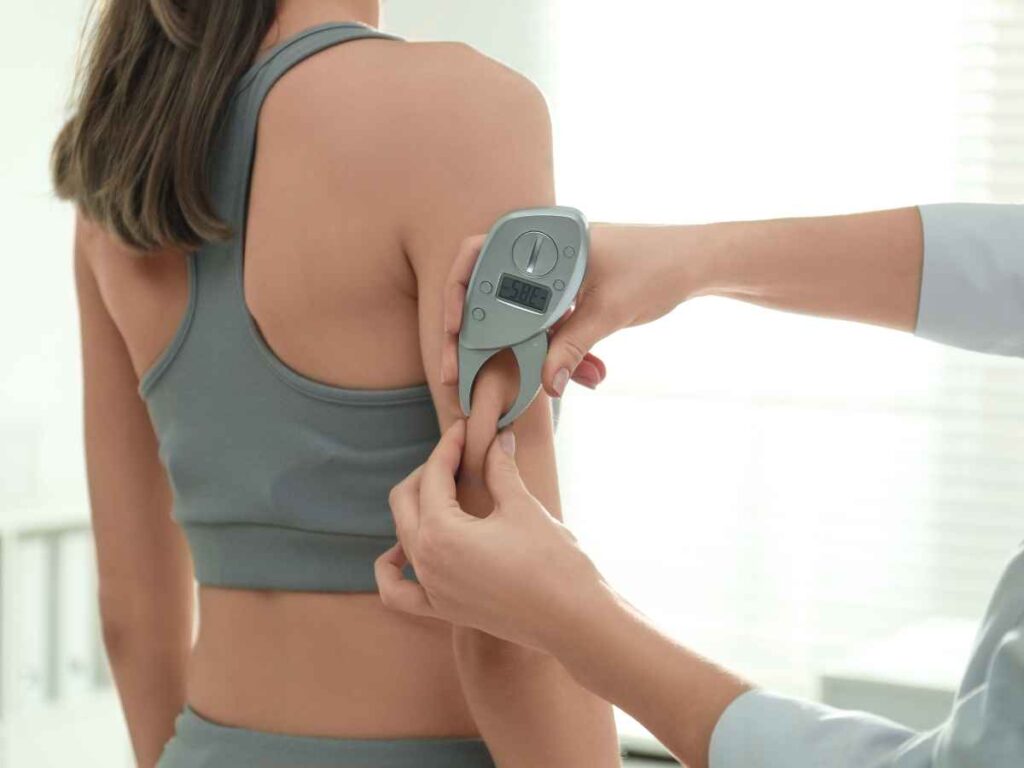 lady getting her body fat percentage measured