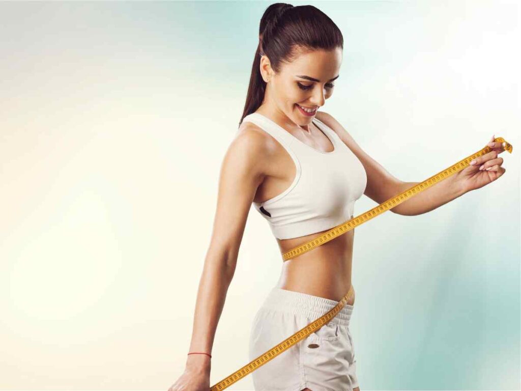 lady with inch tape measuring her waist