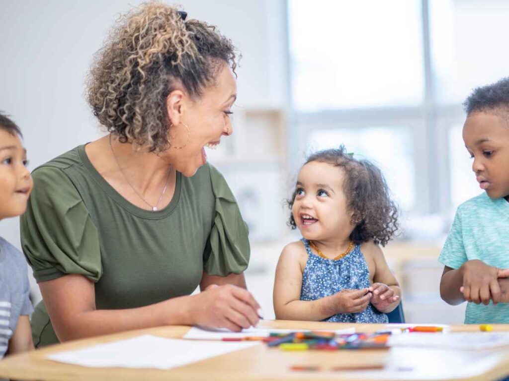 lady helping children study as a volunteer