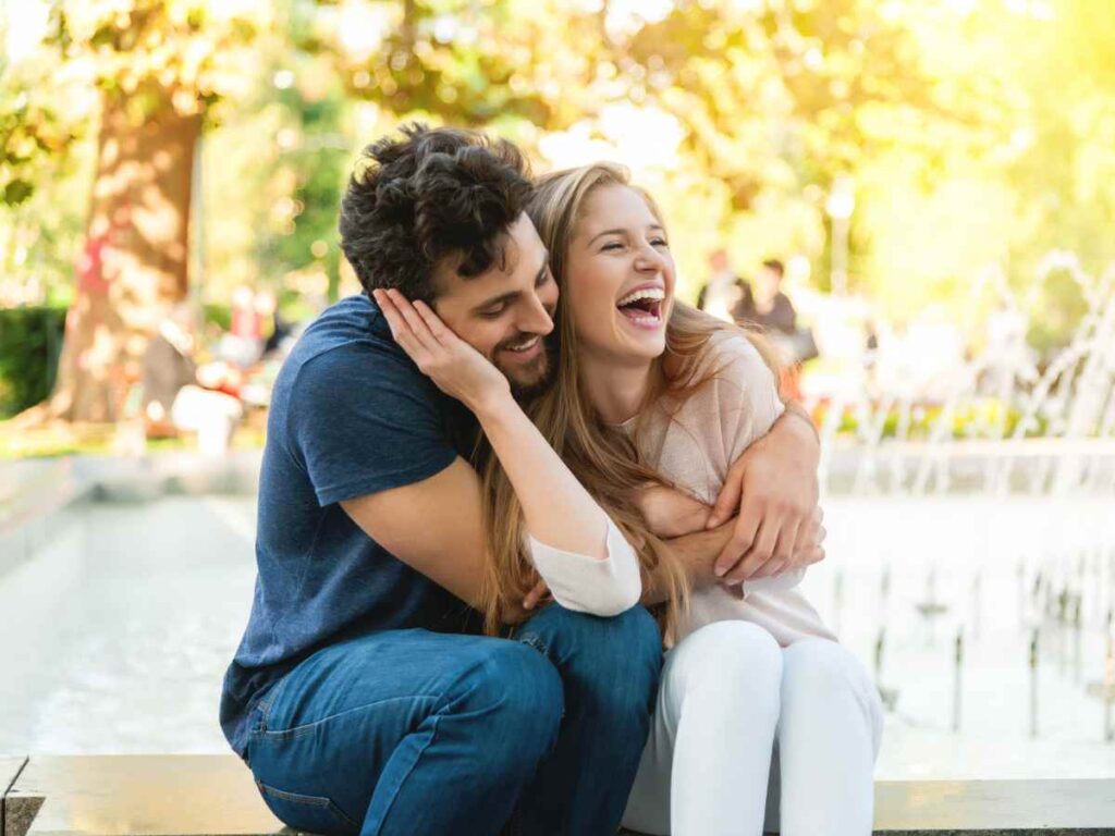 too happy couple sitting in a park