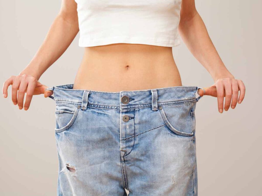 lady checking her weight with the help of clothes