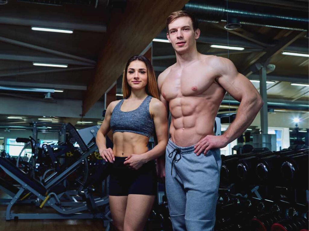 couple showing their muscles at the gym