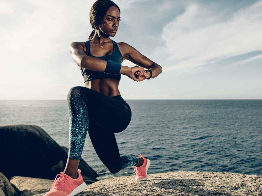 lady doing ballistic stretches at the beach