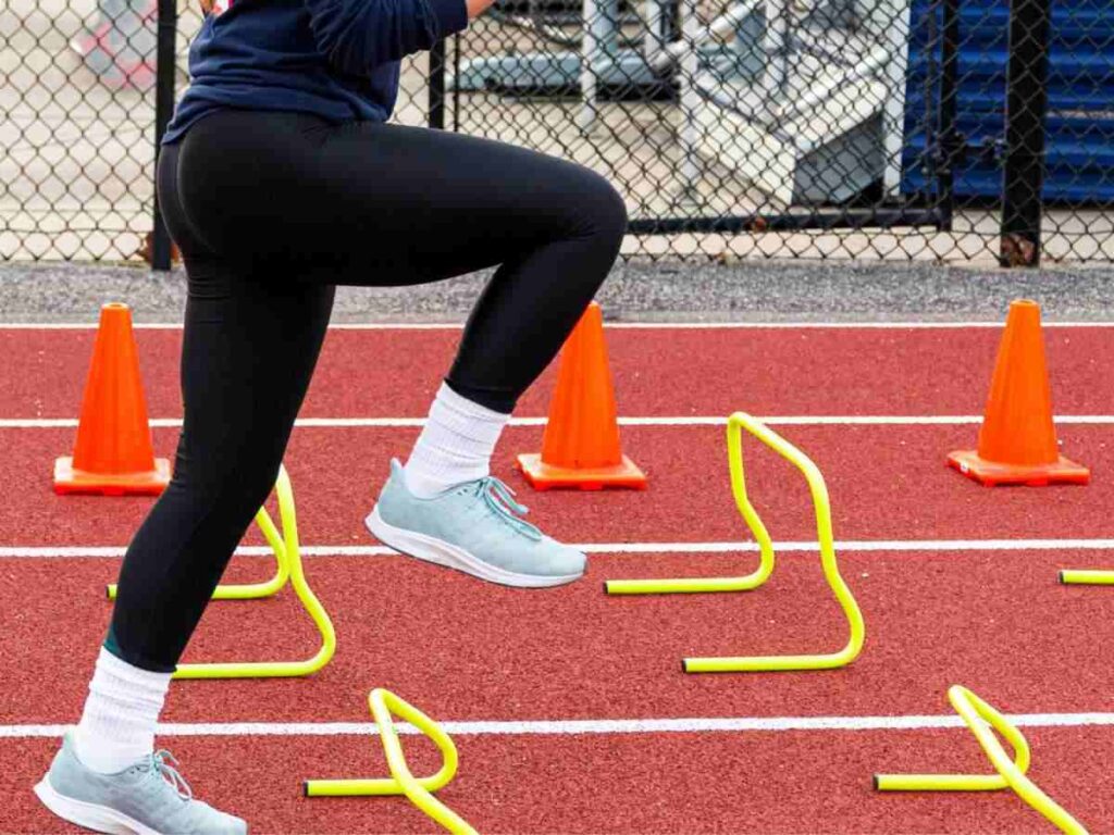 woman doing agility drills in the stadium