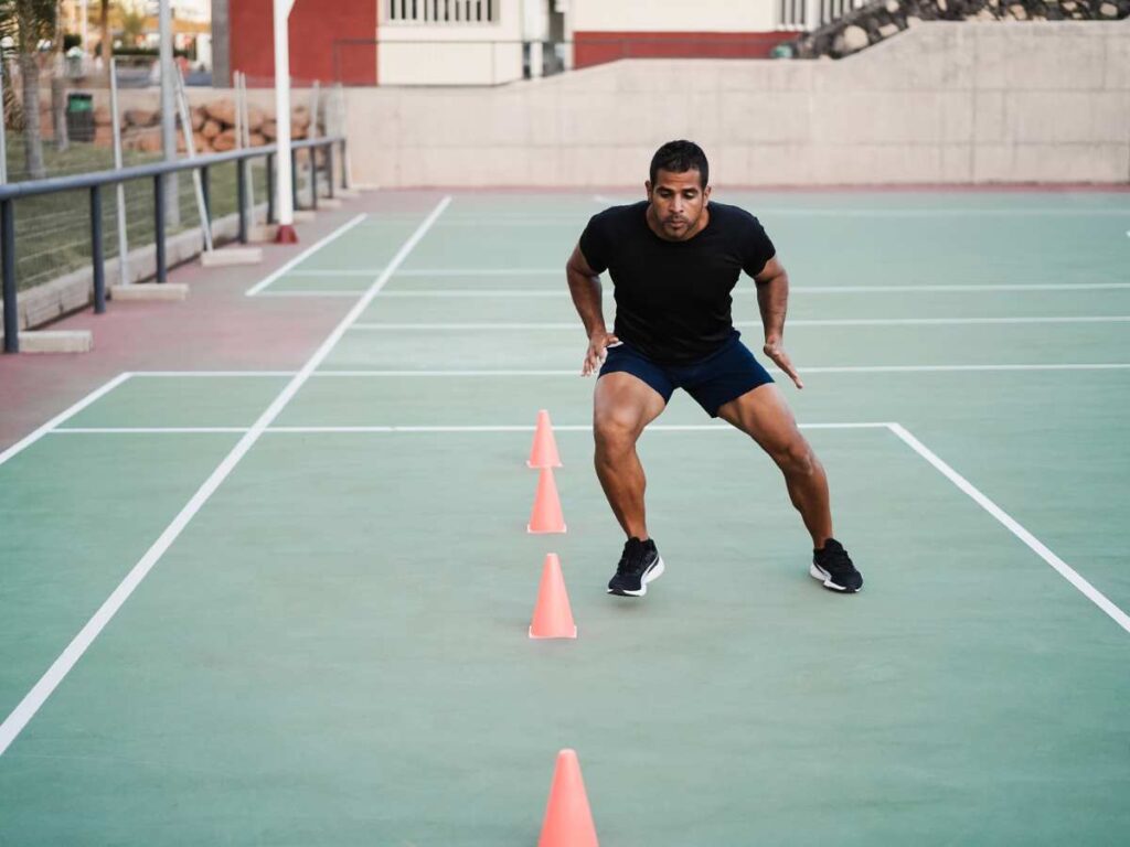 man doing agility cone drills in the stadium